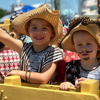 a little girl sitting on a bench