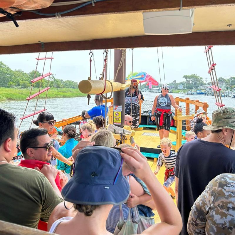 a group of people on a boat looking at the camera